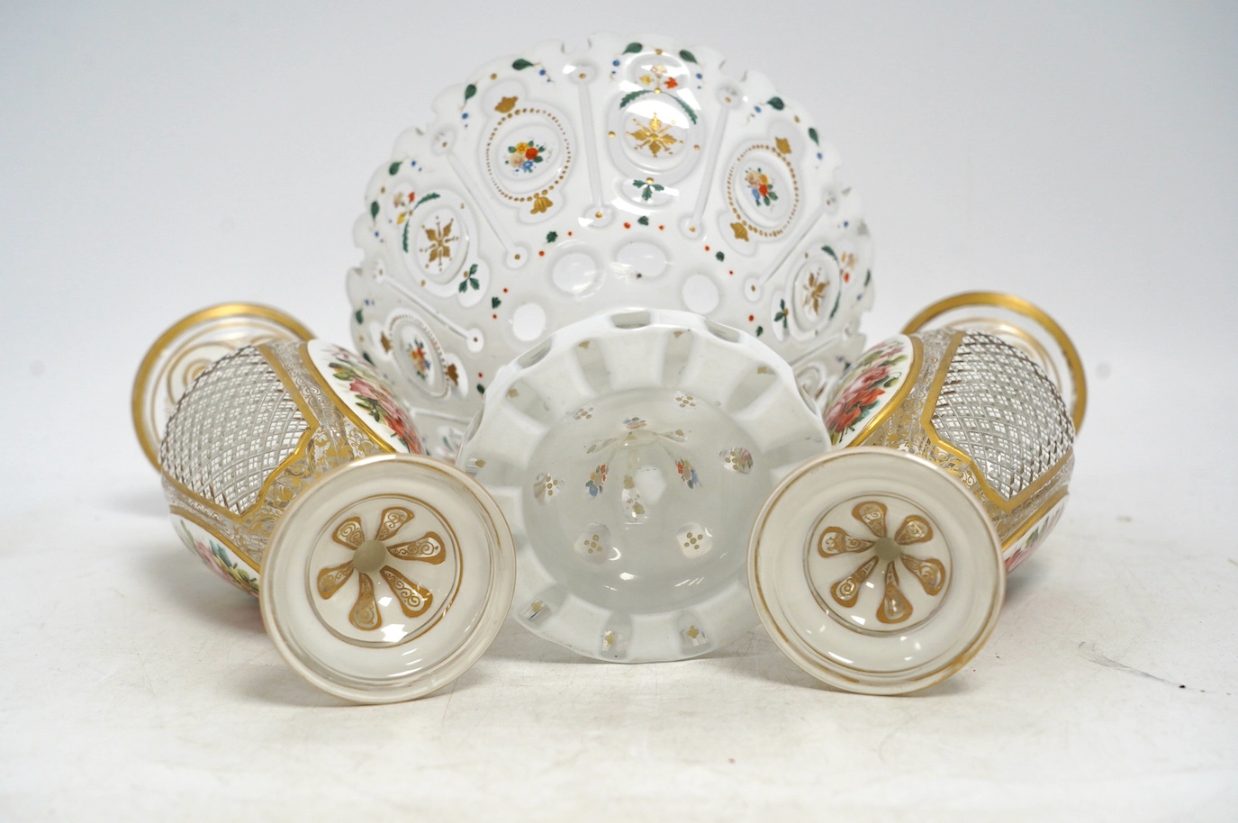 A pair of late 19th century Bohemian enamelled overlaid glass vases, and a similar overlaid glass comport. Condition - vases fair; comport poor